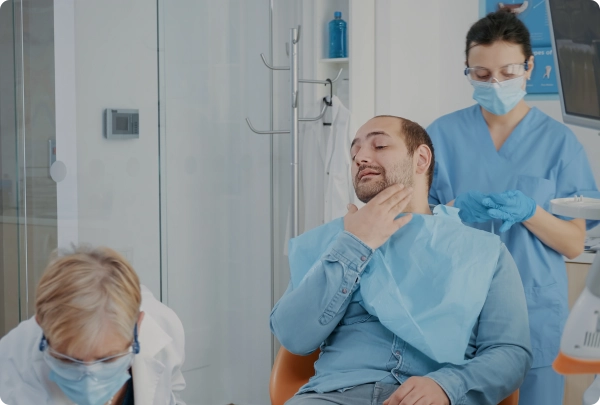 Patient receiving care while discussing emergency dentistry costs